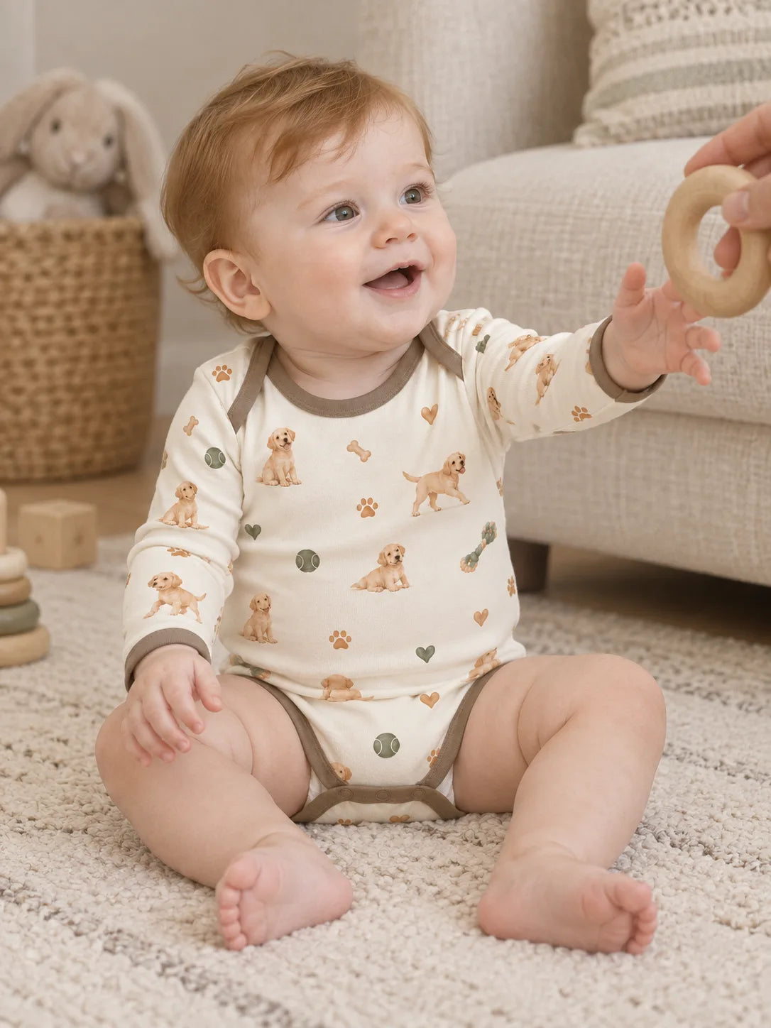 Baby wearing the MossiBaby little labradors long sleeve bodysuit in an indoor lifestyle scene