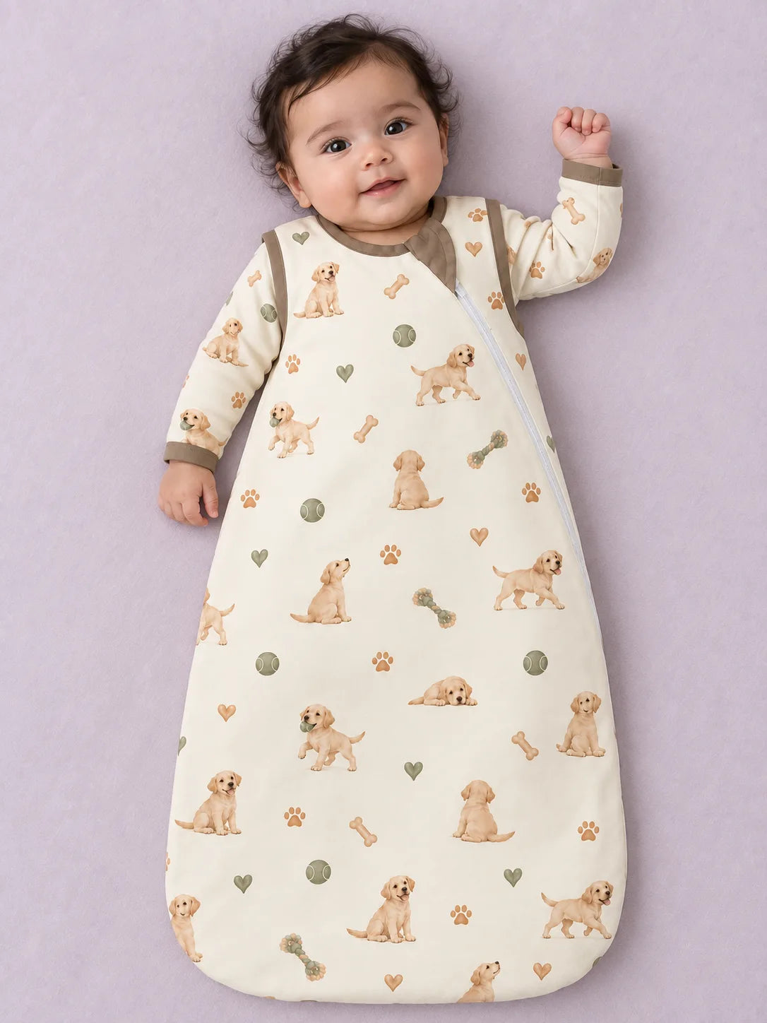Baby wearing the MossiBaby little labradors sleep bag against a pale studio backdrop