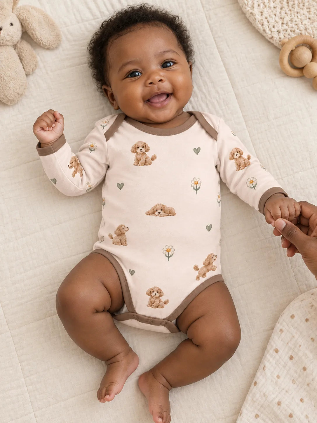 Baby wearing the MossiBaby poodle petals long sleeve bodysuit in an indoor lifestyle scene