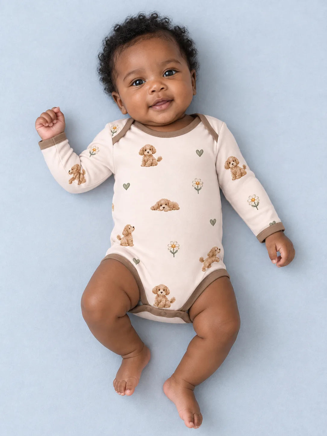 Baby wearing the MossiBaby poodle petals long sleeve bodysuit against a pale studio backdrop