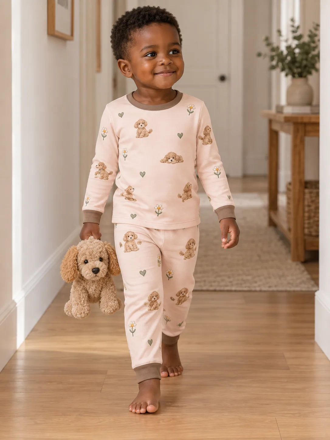 Child wearing the MossiBaby poodle petals long sleeve pajama set in an indoor lifestyle scene