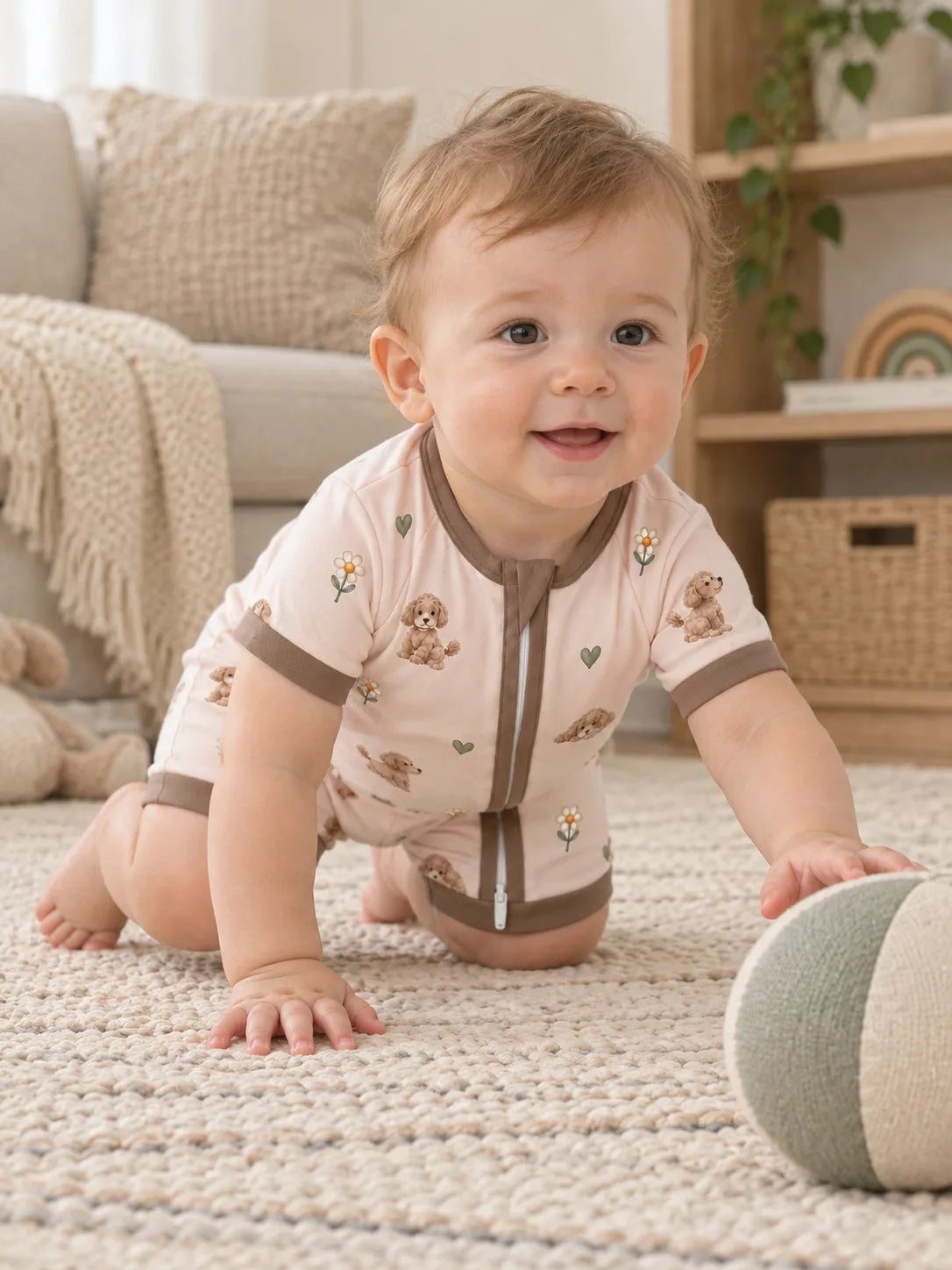Baby wearing the MossiBaby poodle petals shorty romper in an indoor lifestyle scene