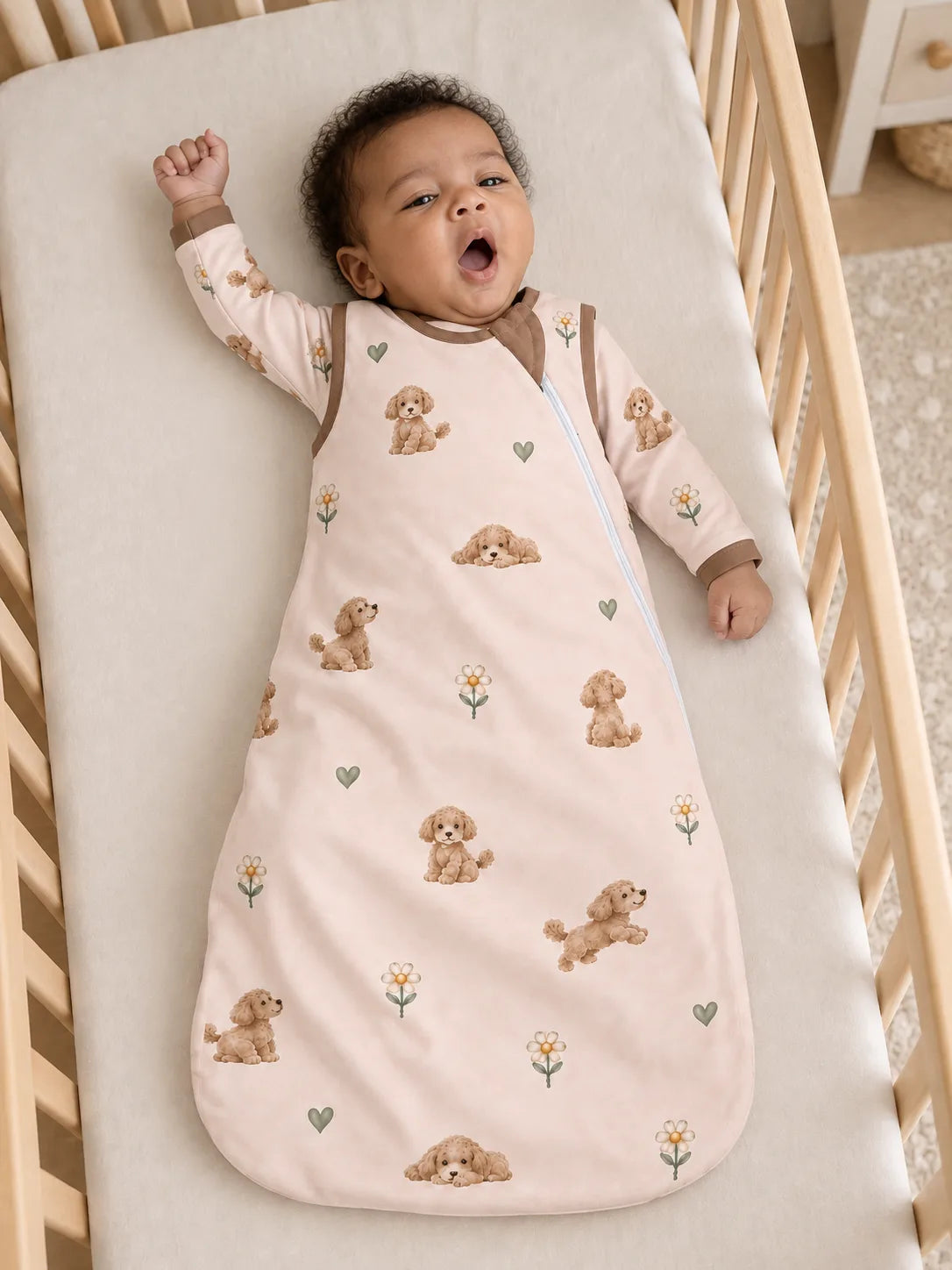 Baby wearing the MossiBaby poodle petals sleep bag in an indoor lifestyle scene