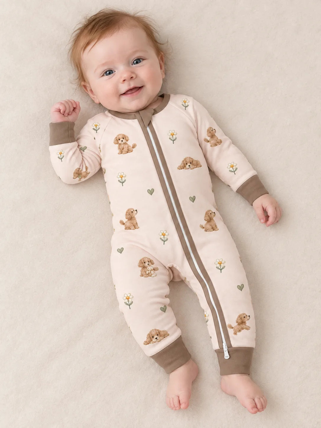 Baby wearing the MossiBaby poodle petals zipper romper against a pale studio backdrop