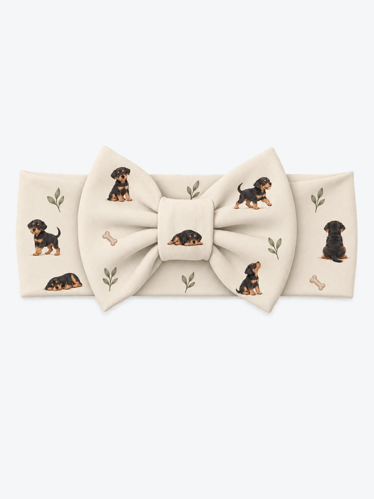 MossiBaby rottie cuddles bow headband featuring Rottweiler puppies and leafy sprigs on oatmeal