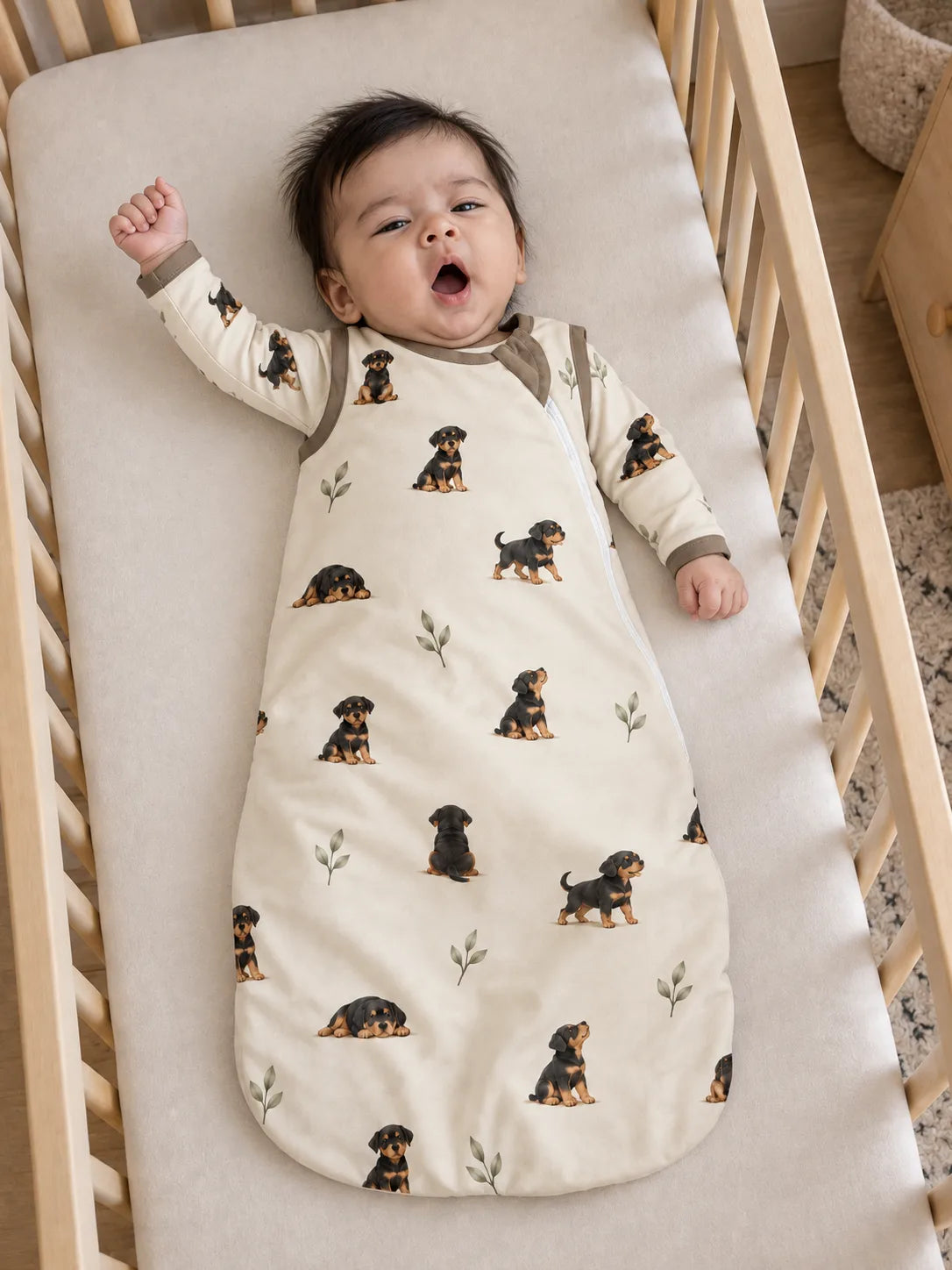 Baby wearing the MossiBaby rottie cuddles sleep bag in an indoor lifestyle scene