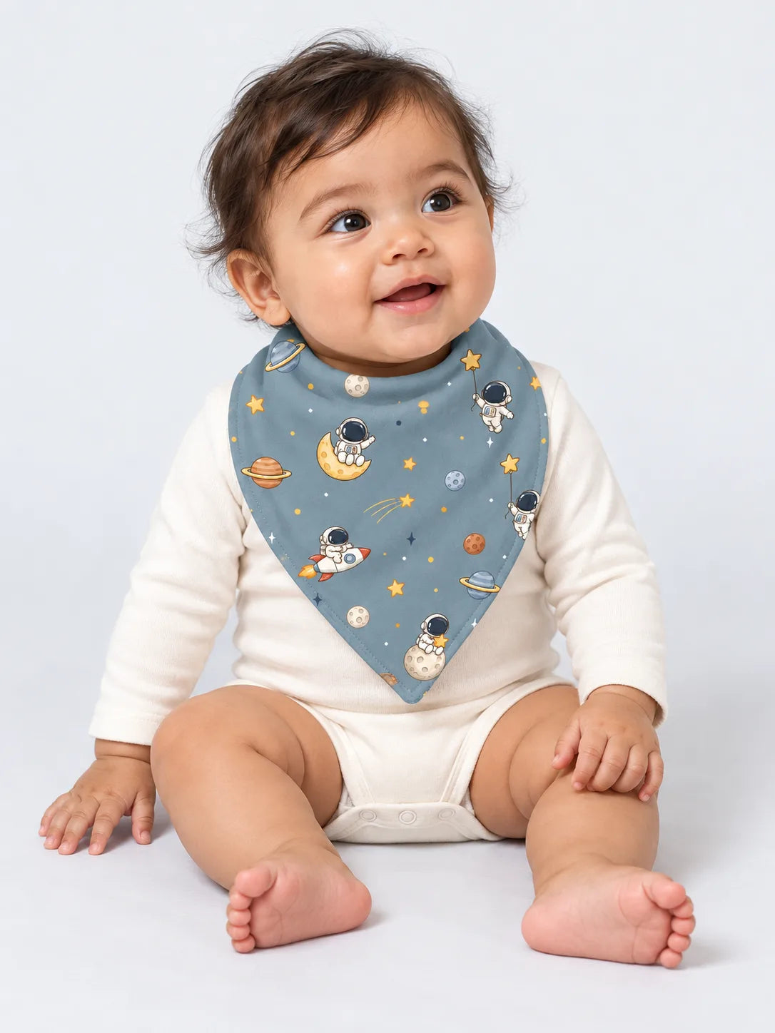 Baby wearing Mossibaby Space Adventures denim blue bamboo bandana bib in a studio