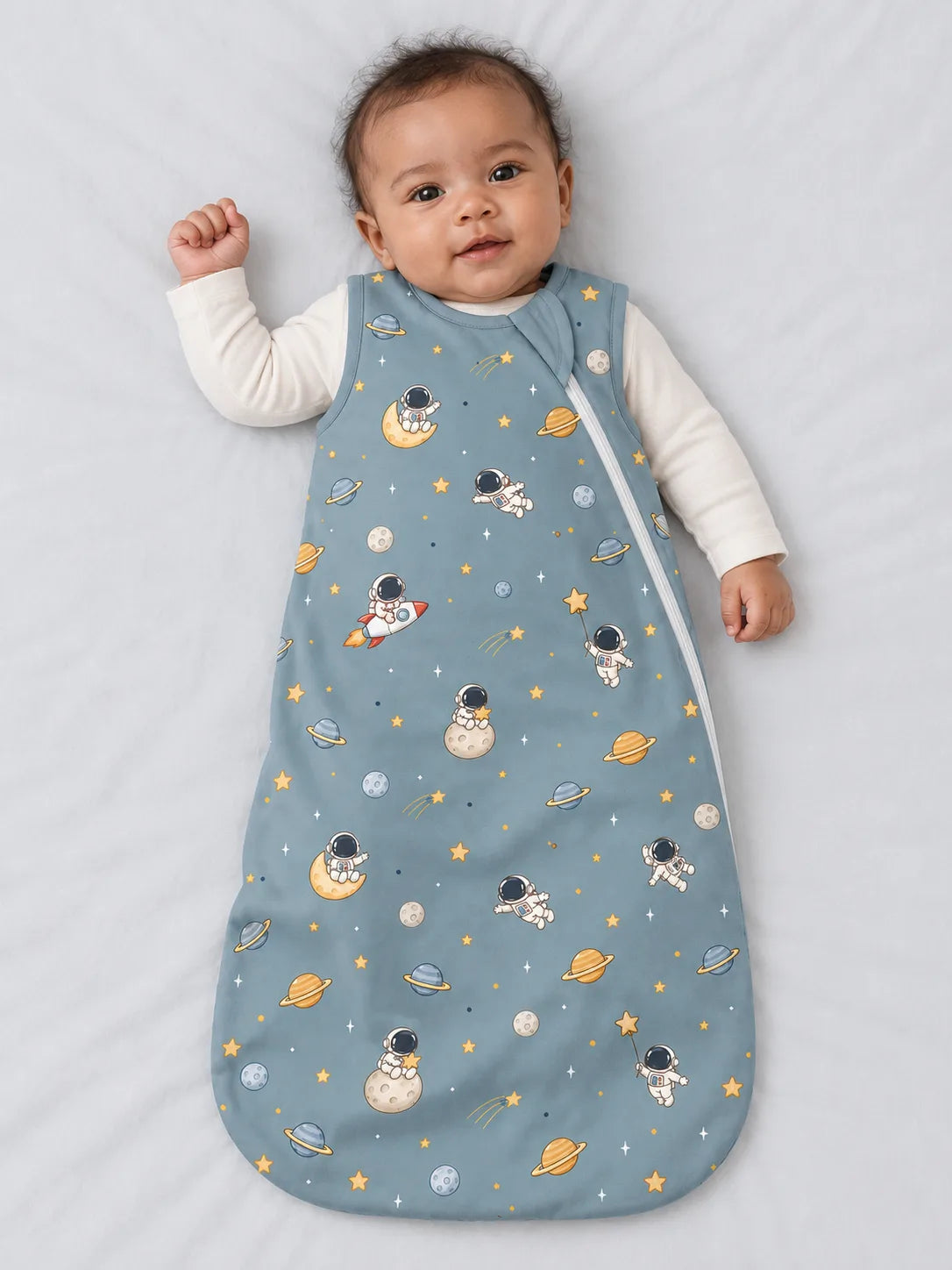 Baby wearing Mossibaby Space Adventures bamboo sleep sack in a studio