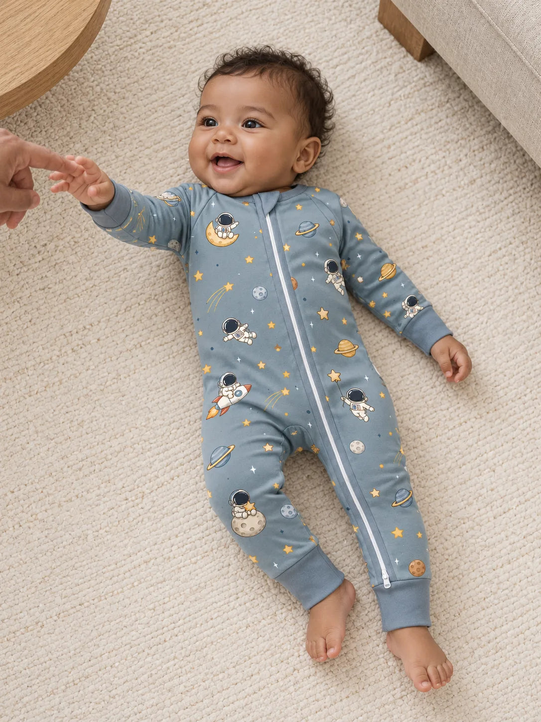 Baby relaxing at home in soft Space Adventures bamboo zipper romper