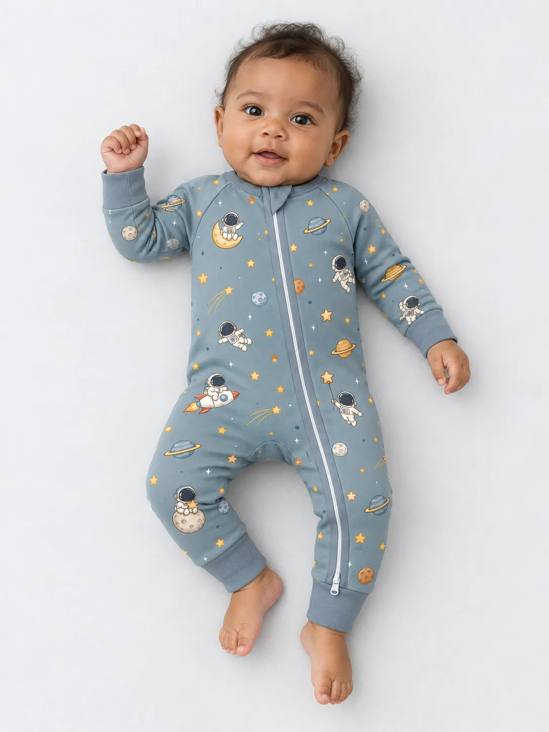 Baby wearing Mossibaby Space Adventures bamboo zipper romper in a minimal studio