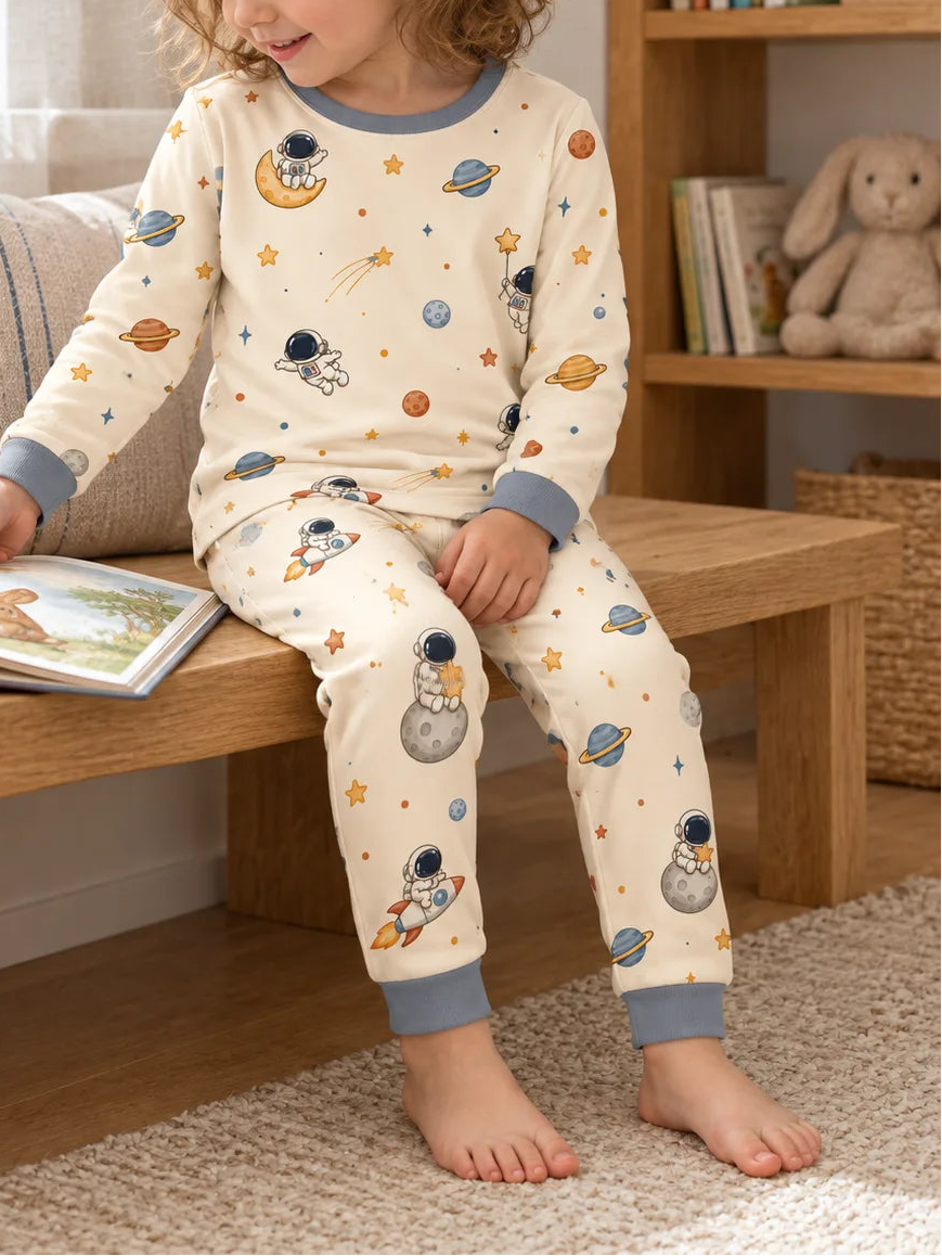 Child wearing the Space Adventures bamboo viscose long sleeve pajama set, showing the space print