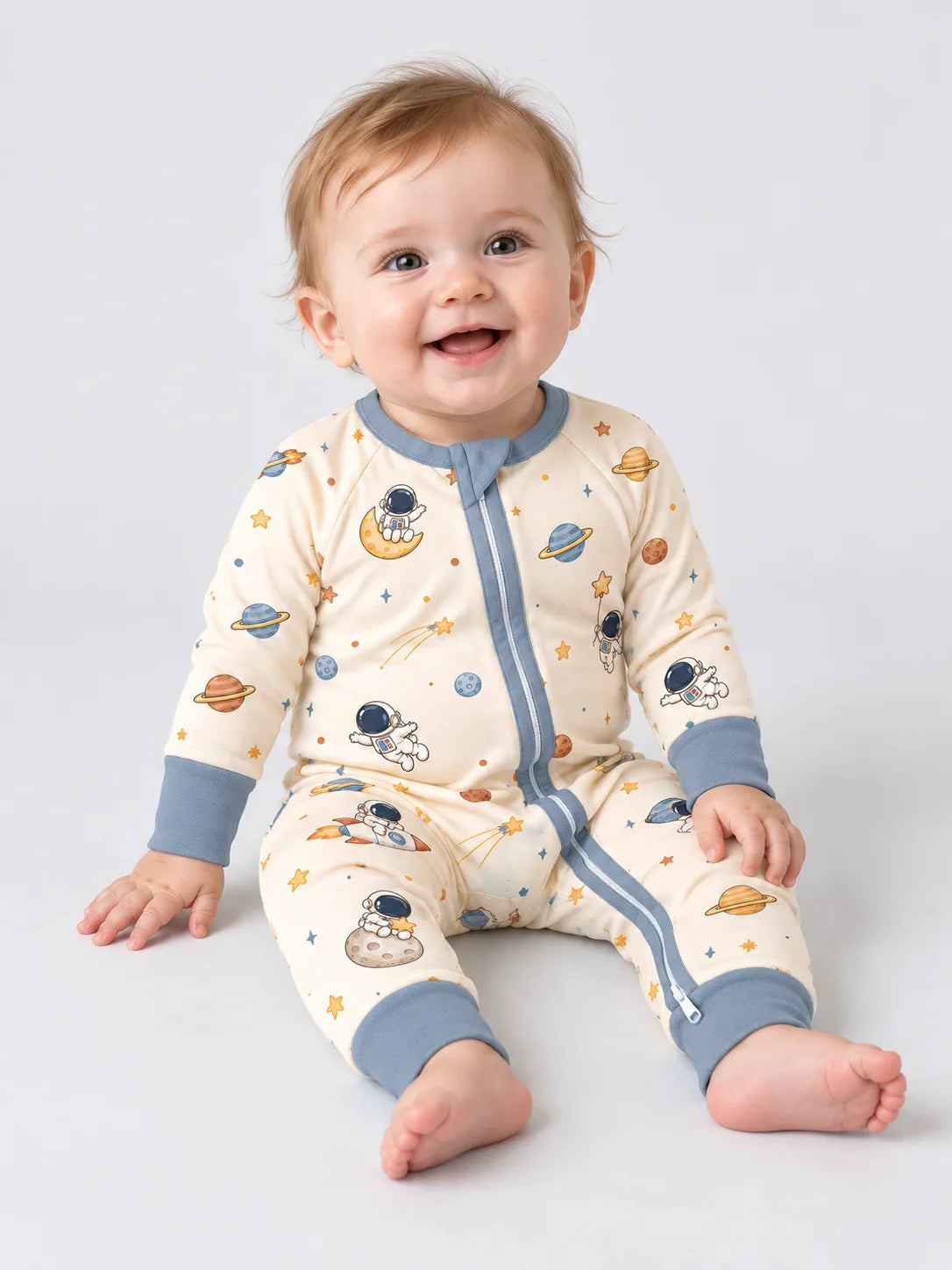 Baby wearing the Space Adventures bamboo viscose zipper romper, showing the space print